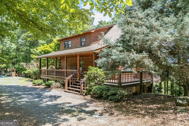 log home featuring covered porch