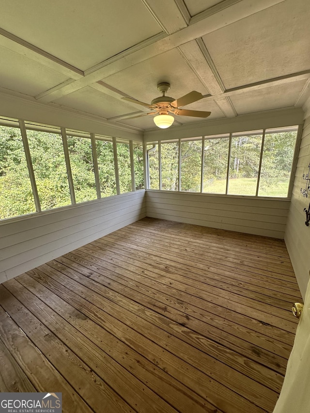 unfurnished sunroom with beamed ceiling, ceiling fan, and coffered ceiling