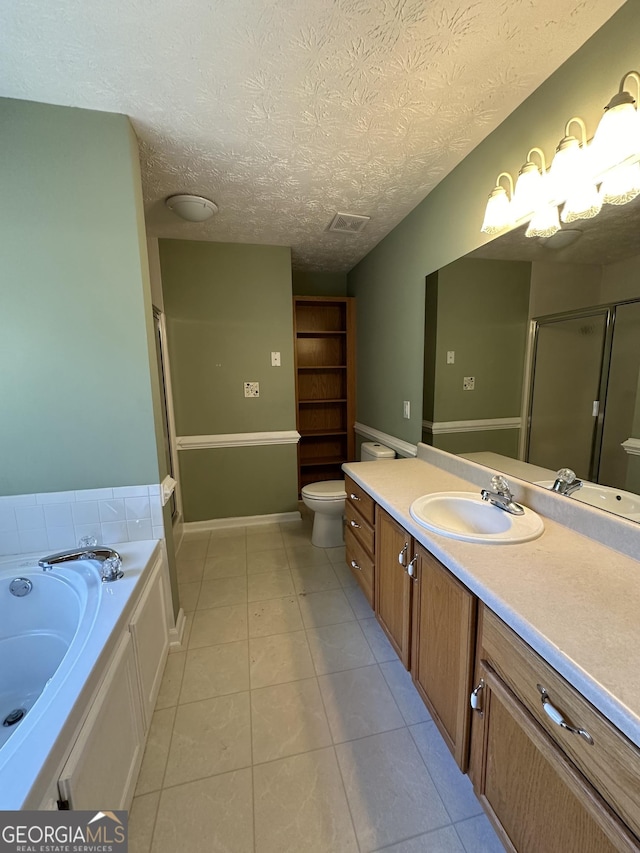 full bathroom featuring tile patterned floors, vanity, a textured ceiling, shower with separate bathtub, and toilet