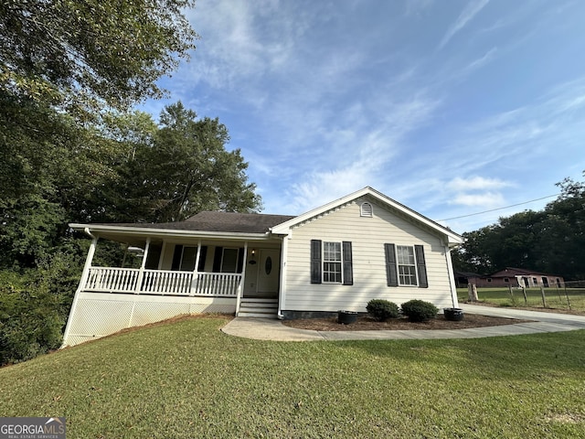 view of front of house with covered porch and a front lawn