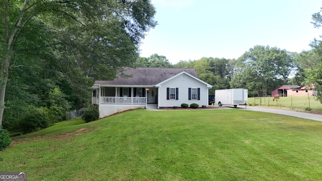 ranch-style home featuring a shed, a porch, and a front yard