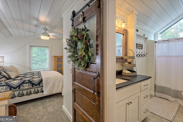 bedroom with ceiling fan, light colored carpet, wooden ceiling, and lofted ceiling