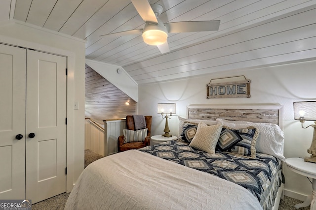 bedroom with carpet flooring, ceiling fan, wooden ceiling, and a closet