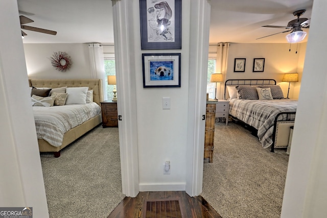 bedroom featuring multiple windows, ceiling fan, and hardwood / wood-style floors