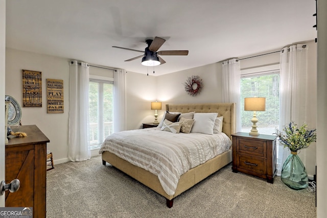 bedroom with ceiling fan and light colored carpet