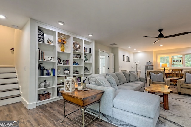 living room featuring hardwood / wood-style flooring and ceiling fan