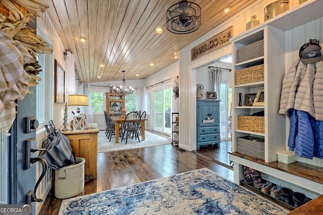 interior space featuring a chandelier, dark wood-type flooring, and wooden ceiling