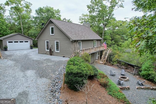 view of front facade with an outdoor structure, a garage, and a deck