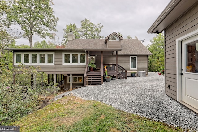 rear view of property with central air condition unit and a wooden deck