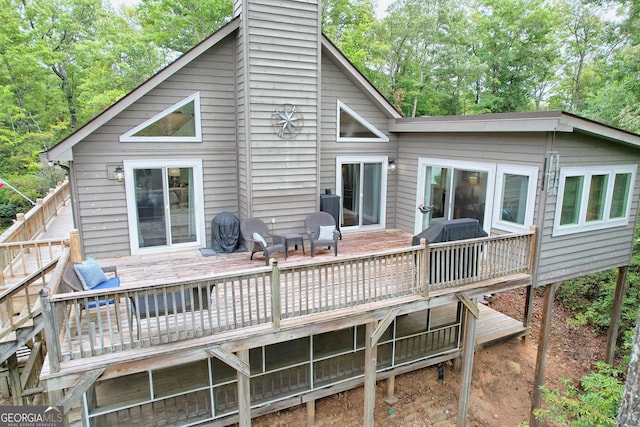 back of property featuring a wooden deck