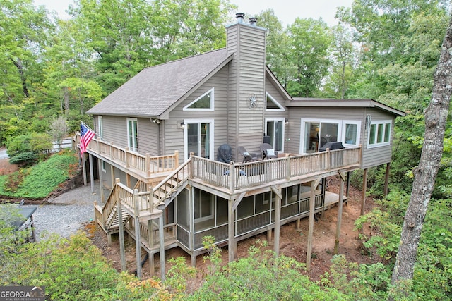 back of house featuring a deck and a sunroom