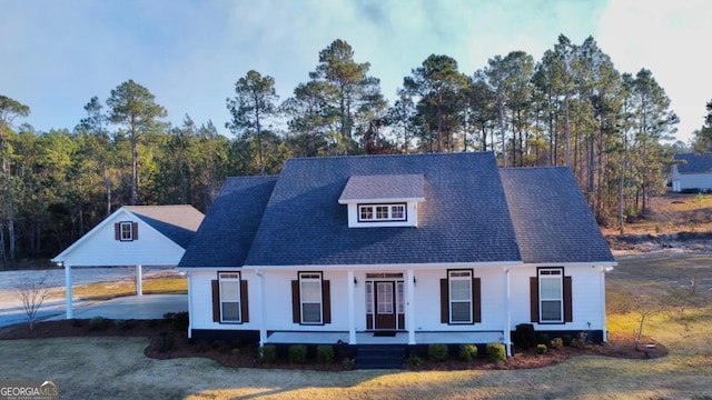 view of front facade with a front lawn, covered porch, and a carport