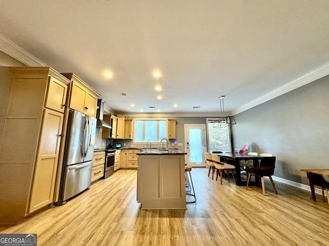 kitchen with light brown cabinets, a center island, light hardwood / wood-style flooring, decorative light fixtures, and appliances with stainless steel finishes