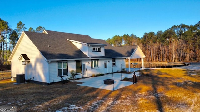 rear view of house featuring a patio area, a yard, and central AC unit