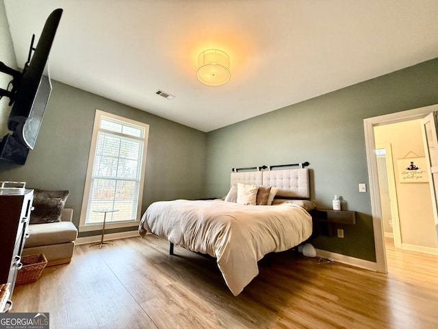 bedroom with light hardwood / wood-style floors