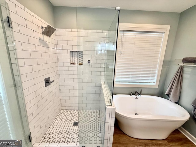 bathroom with separate shower and tub and hardwood / wood-style flooring