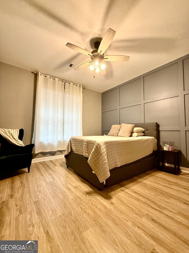 bedroom featuring ceiling fan and light wood-type flooring