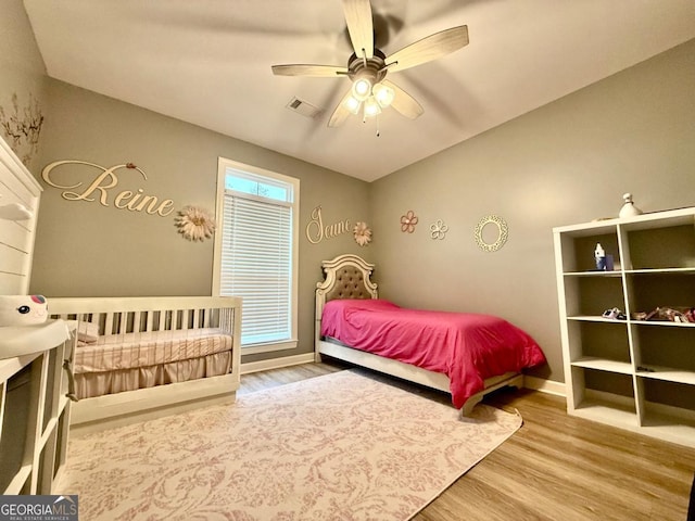 bedroom with hardwood / wood-style floors and ceiling fan