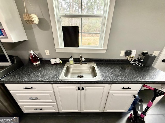 kitchen featuring sink, white cabinets, and plenty of natural light