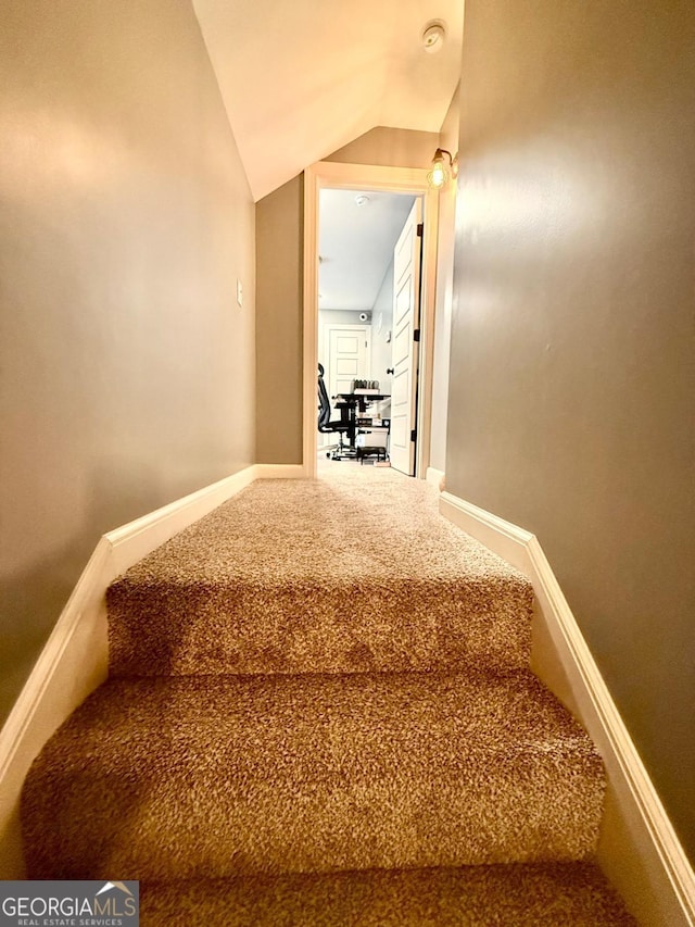 staircase with vaulted ceiling