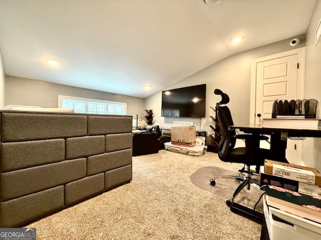 carpeted office space with vaulted ceiling