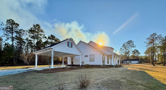 farmhouse-style home with a carport and a front yard