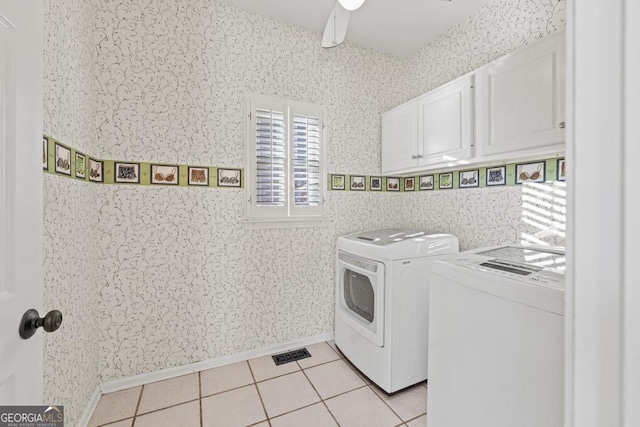 laundry area with washer and dryer, light tile patterned flooring, cabinets, and ceiling fan