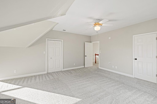 additional living space featuring ceiling fan and carpet