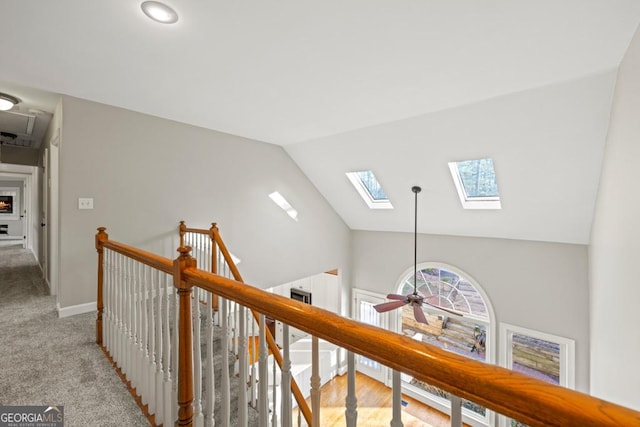 corridor with light colored carpet and lofted ceiling