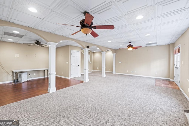 unfurnished living room featuring carpet, ornate columns, and ceiling fan