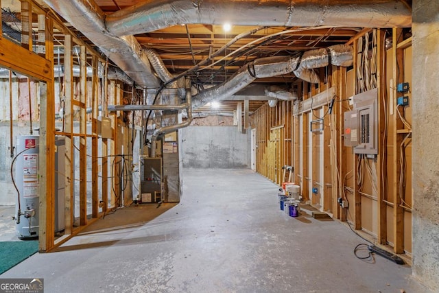 basement with heating unit, electric panel, and water heater