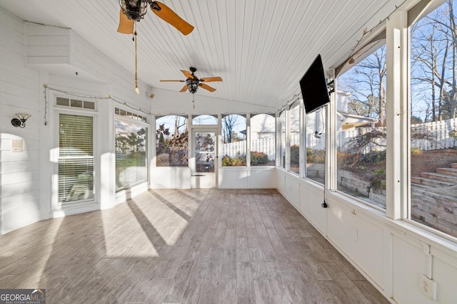 unfurnished sunroom with vaulted ceiling, ceiling fan, and wood ceiling