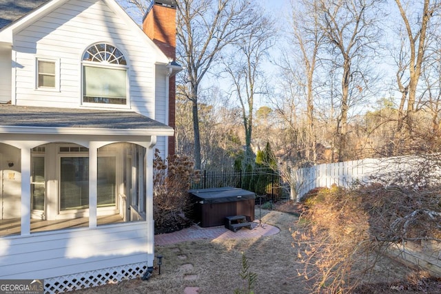 view of side of property with a hot tub