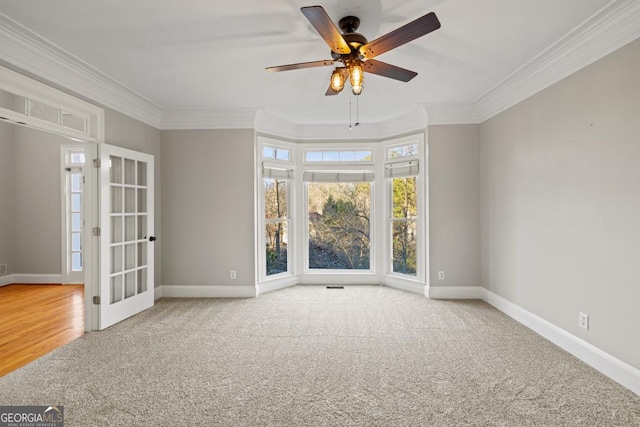 unfurnished room with carpet flooring, ceiling fan, and ornamental molding