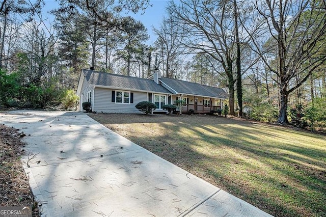 ranch-style house featuring a porch and a front lawn