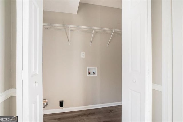 washroom with dark hardwood / wood-style floors and hookup for a washing machine