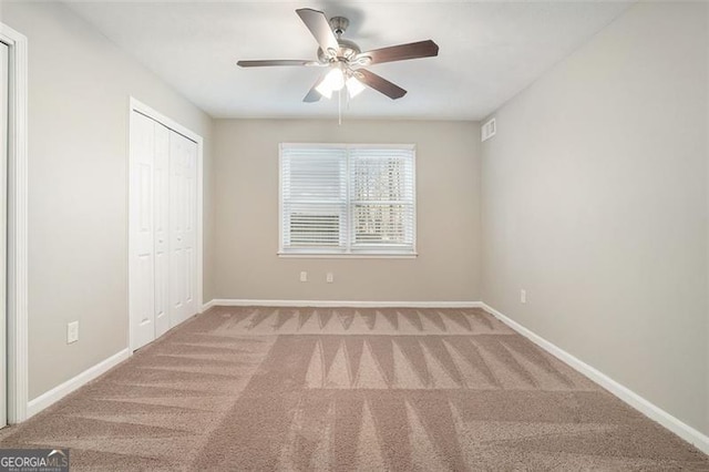 unfurnished bedroom with carpet floors, a closet, and ceiling fan