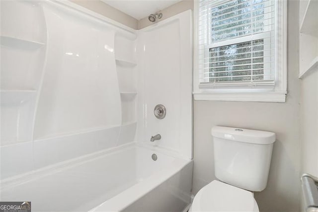 bathroom with bathtub / shower combination and toilet