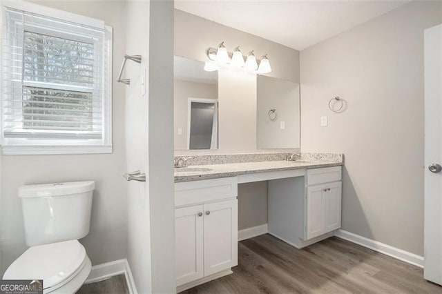 bathroom featuring hardwood / wood-style flooring, vanity, and toilet