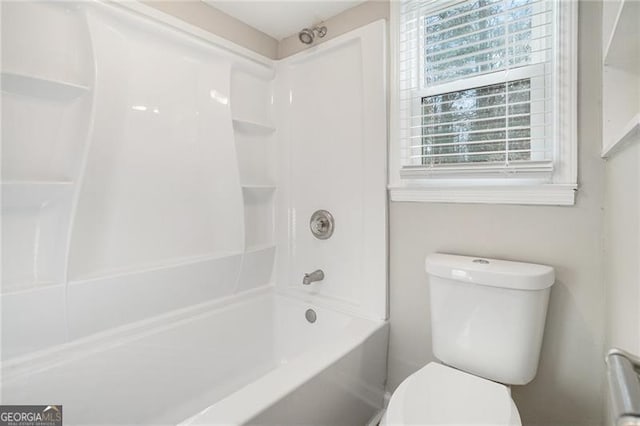 bathroom featuring bathtub / shower combination and toilet