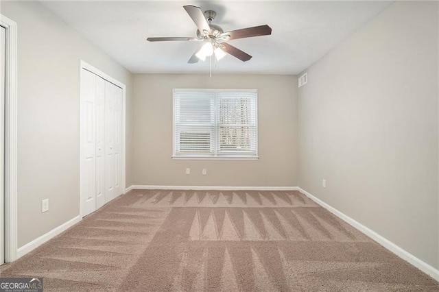 unfurnished bedroom with ceiling fan, carpet floors, and a closet