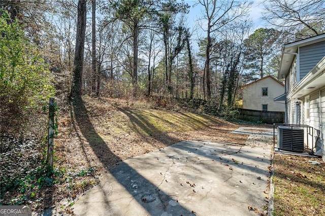 view of yard featuring central AC and a patio area