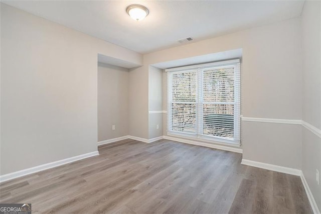 spare room featuring hardwood / wood-style floors