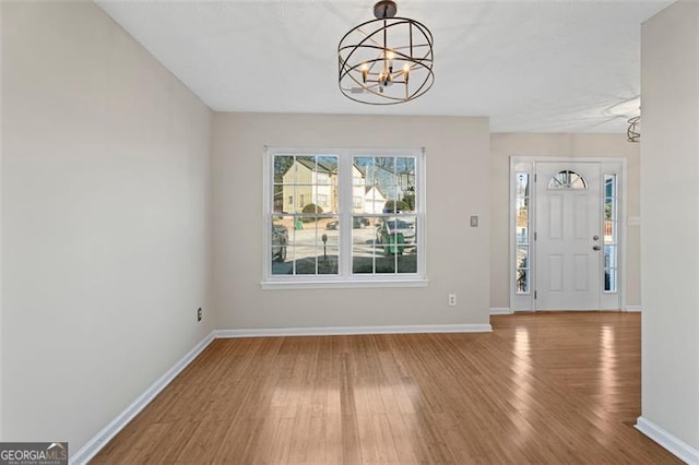 entryway with a chandelier and hardwood / wood-style flooring