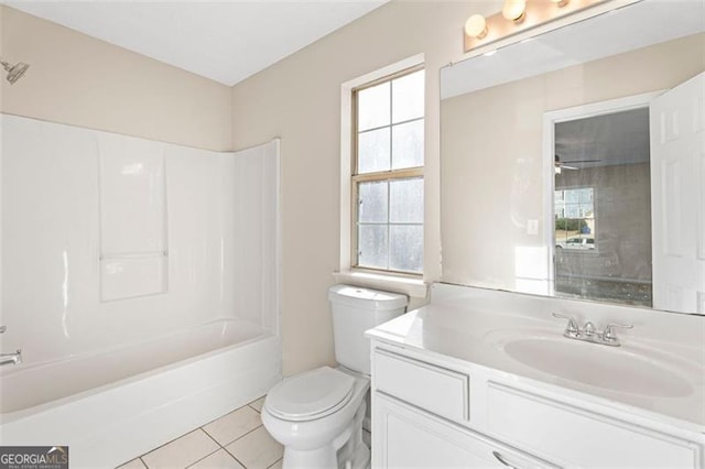 full bathroom with bathtub / shower combination, tile patterned floors, a healthy amount of sunlight, and toilet