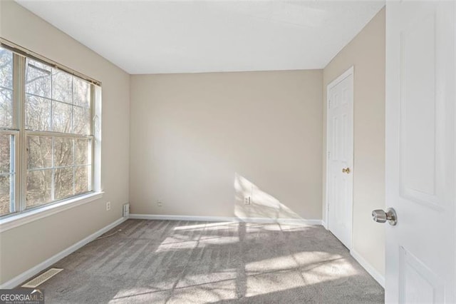 unfurnished room featuring carpet flooring