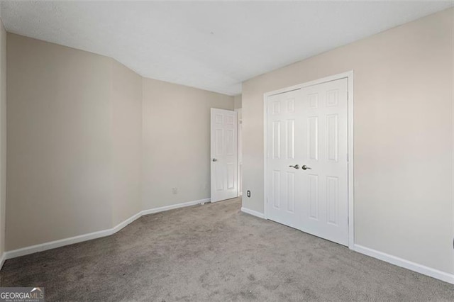 unfurnished bedroom featuring light colored carpet