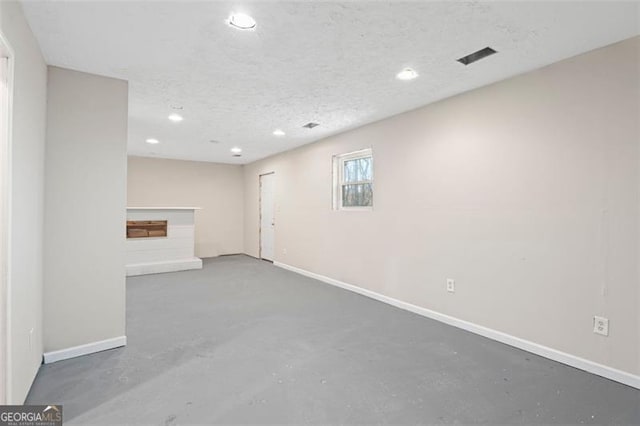 basement featuring a textured ceiling