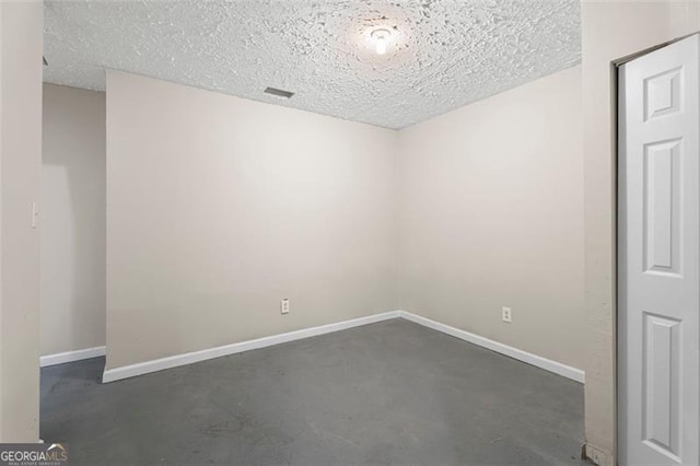 empty room featuring a textured ceiling