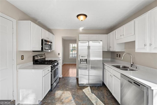 kitchen featuring white cabinets, stainless steel appliances, and sink